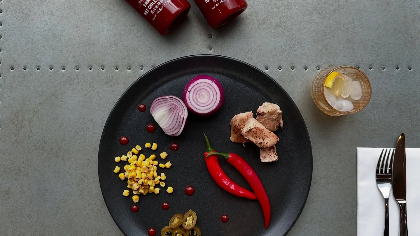 Fresh red onion, chillies, sweetcorn and jalapeños ready for the oven.