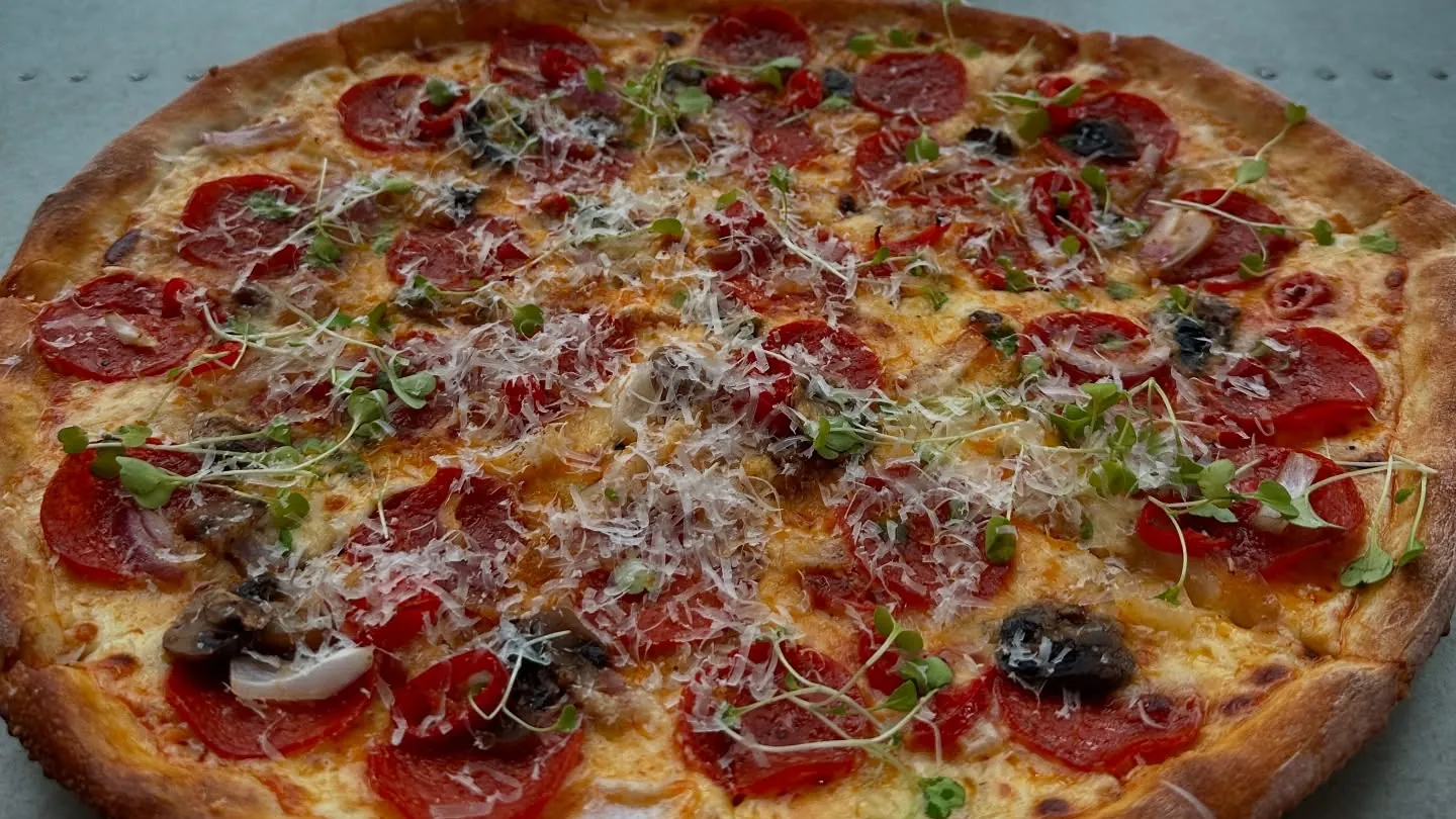 A pepperoni pizza on a table by the window at Canary Wharf.
