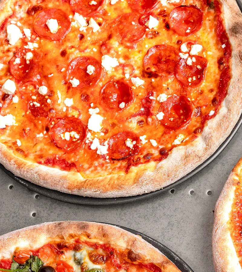 Pepperoni and crumbled feta pizza fresh from the oven.