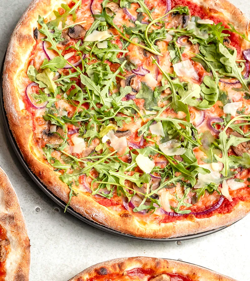 Rocket and parmesan pizza from above.